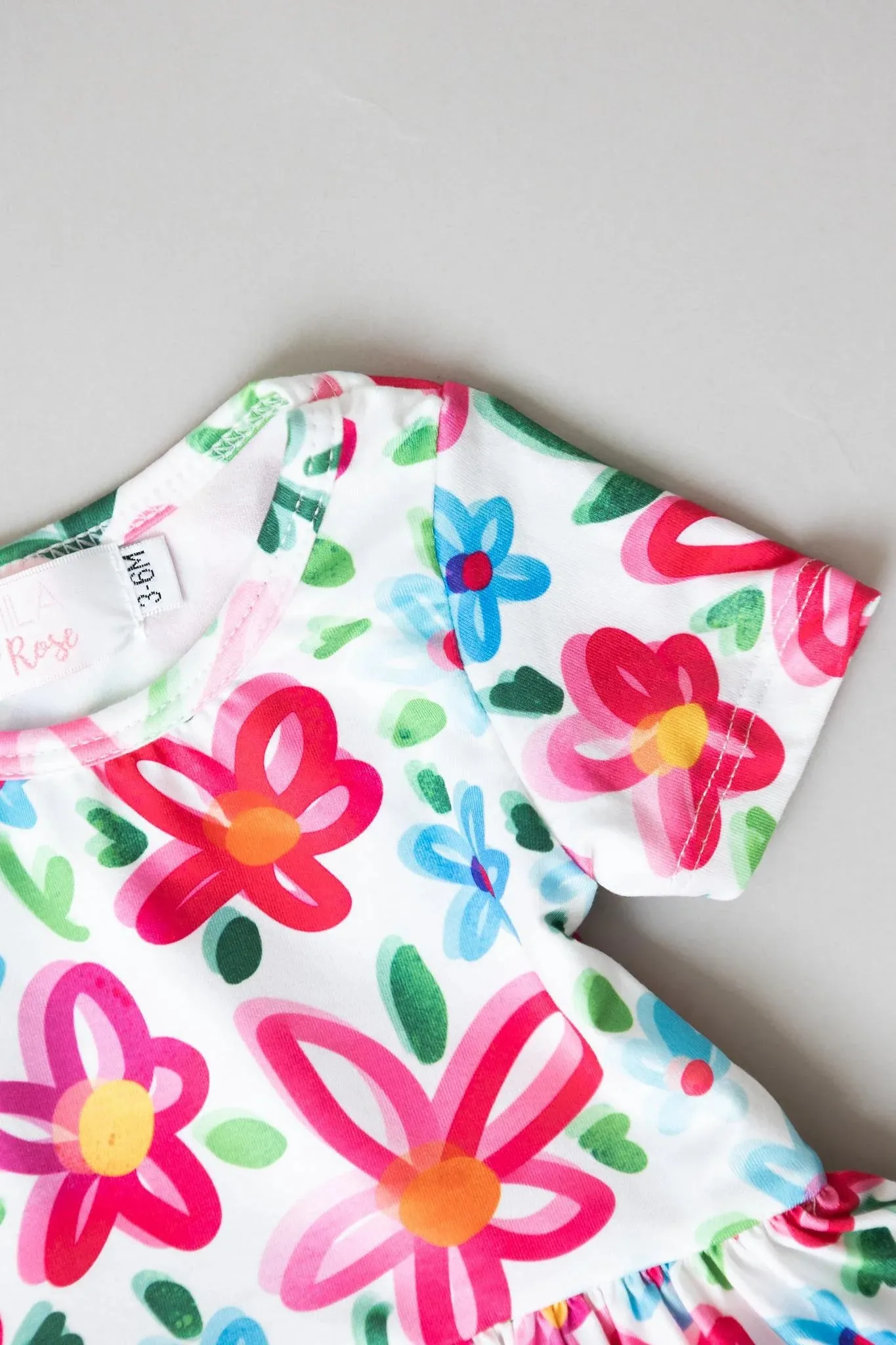 NEON FLORAL S/S TWIRL BODY SUIT